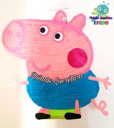 a paper plate shaped like a peppa pig hanging from a hook on a wall