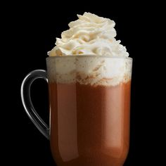 a cup filled with whipped cream on top of a table