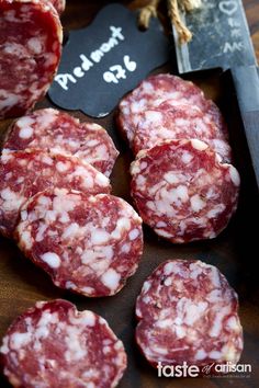 several pieces of meat sitting on top of a cutting board