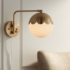 a light that is on the side of a wall next to a chair and pillow