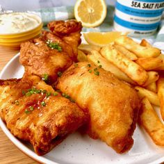 a white plate topped with fried fish and french fries