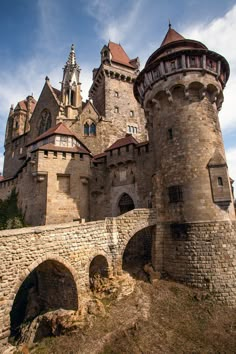 an old castle with two towers and a bridge