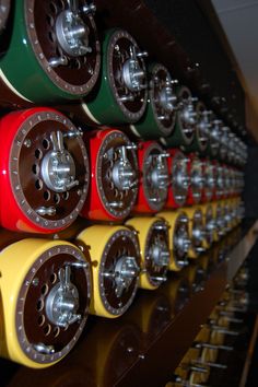 there are many different colors and sizes of wheels on the rack in the store or office