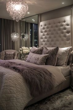 a bedroom with a large bed and chandelier