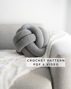 a large gray knot sitting on top of a couch