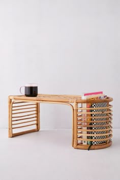 a wooden table with a cup on top of it next to a stack of books