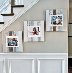 some pictures are hanging on the wall next to a banister and stair case in a house