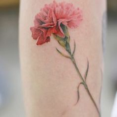 a woman's leg with a flower tattoo on it