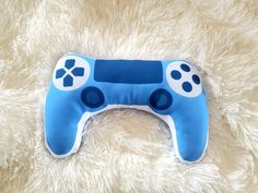 a close up of a blue controller on a furry surface