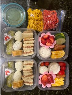 four plastic containers filled with different types of food