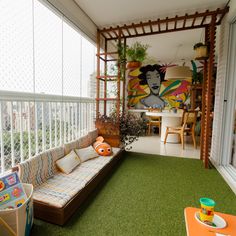 a small balcony with green grass on the floor