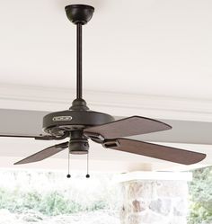 a ceiling fan that is hanging from the ceiling