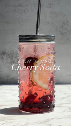 a drink in a mason jar with the words how to make cherry soda on it