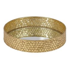 a gold bang bracelet with circles and dots in the middle, on a white background