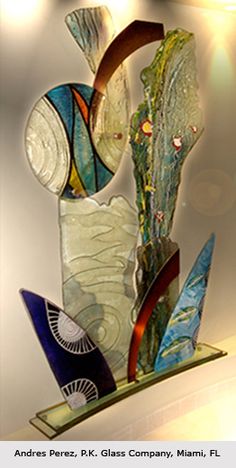 a glass sculpture is displayed on a shelf