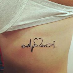 a woman with a heartbeat tattoo on her stomach