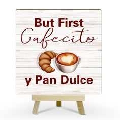 a sign that says, but first cafetto y pan dulce with a cup of coffee