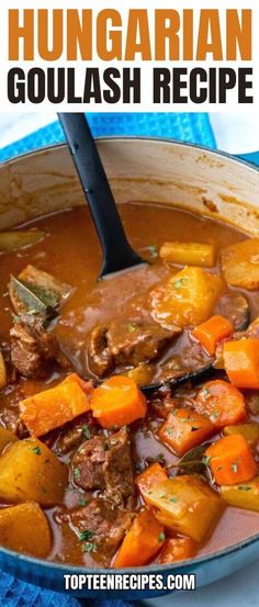 a bowl filled with beef stew and carrots on top of a blue towel next to a