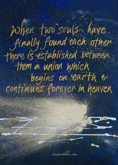 a painting with words written on it in gold and blue ink, against a dark background