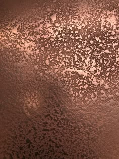 the surface of an ice covered window with brown and white dots on it, as seen from above