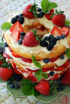 a cake with strawberries and blueberries on top