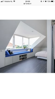 an image of a bedroom with white walls and blue bed linens on the floor