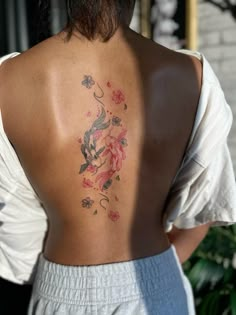 a woman with a tattoo on her back