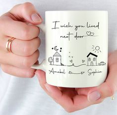 a person holding a coffee mug with writing on it