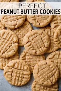 peanut butter cookies are arranged in rows on a baking sheet, ready to be eaten