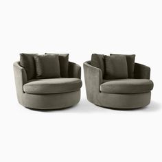 two grey chairs with pillows on them and one chair is sitting in front of the other