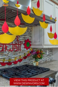 the kitchen is decorated with paper decorations and hanging from the ceiling over the stove top