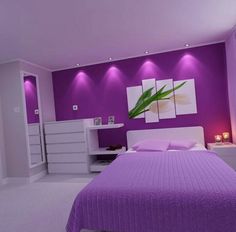 a bedroom with purple walls and white furniture