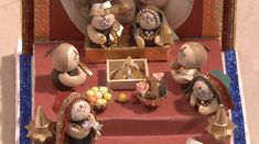 a group of small figurines sitting on top of a red carpeted floor