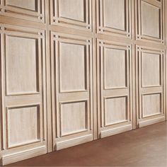 an empty room with wooden paneling on the walls