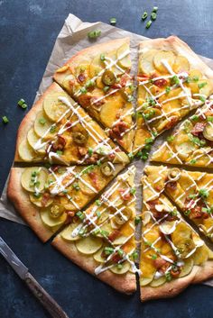 a pizza with many toppings cut into eight pieces