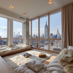 a living room filled with lots of furniture and large windows overlooking the cityscape