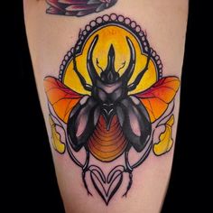 a black and yellow tattoo with a bee on it