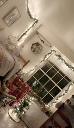 the living room is decorated for christmas with garlands and lights on the windowsill