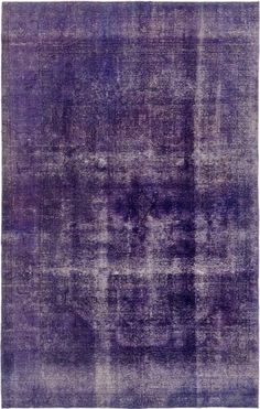 a purple rug with an abstract design on the top and bottom, it is made out of