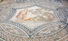 a mosaic floor with an image of a woman on it