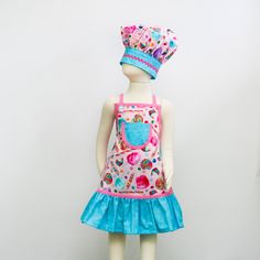 a doll is wearing a pink and blue dress with a hat on it's head