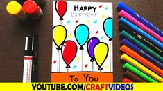 a birthday card with balloons on it next to markers and crayon pencils