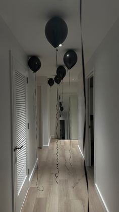 the hallway is decorated with black balloons and streamers