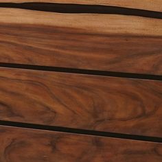 a close up of a wooden dresser with black handles and wood grain on the drawers