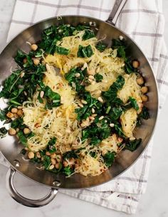 spinach and chickpeas with parmesan cheese in a frying pan