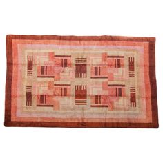 an orange and pink rug with squares on the bottom, in different sizes and colors