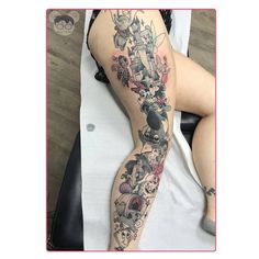 a woman's leg with tattoos on it and an image of cartoon characters in the background