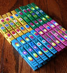 several colorful wooden blocks sitting on top of a wooden table with flowers painted on them