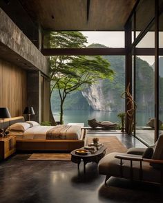 a bedroom with a large window overlooking the water and mountains is pictured in this image