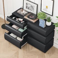 a black desk with drawers and pictures on it